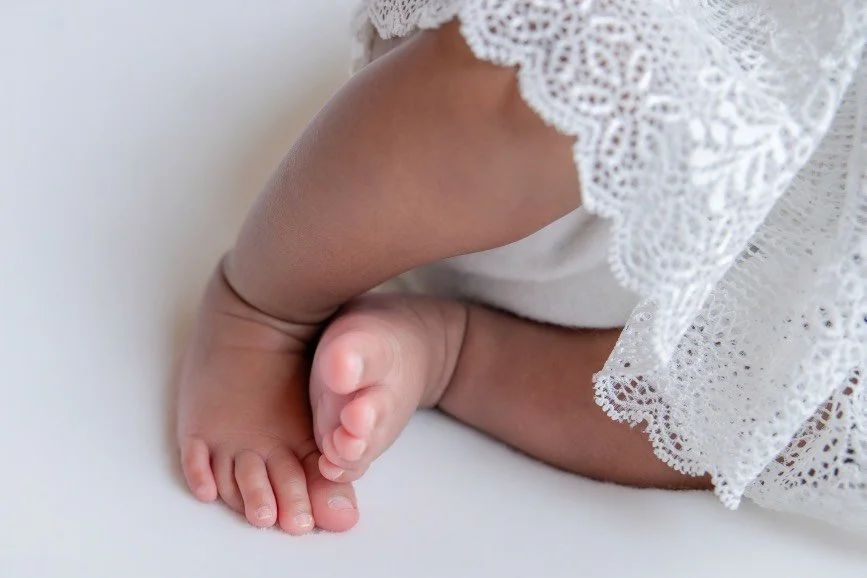 Timeless newborn and sibling portrait showcasing a gentle sibling bond in a studio serving Bucks County, PA