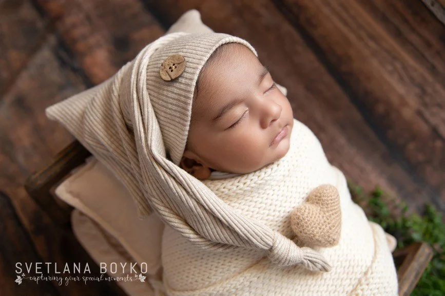 Professional newborn photographer in Bucks County PA capturing sleepy newborn baby in studio
