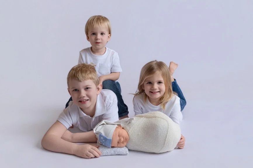 Safety-focused newborn and sibling photography captured in a professional studio serving Bucks County, PA