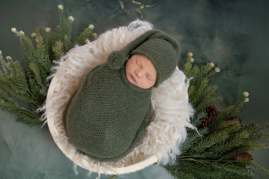 Professional newborn portrait of baby girl wrapped in pink blanket photographed in West Windsor NJ studio.