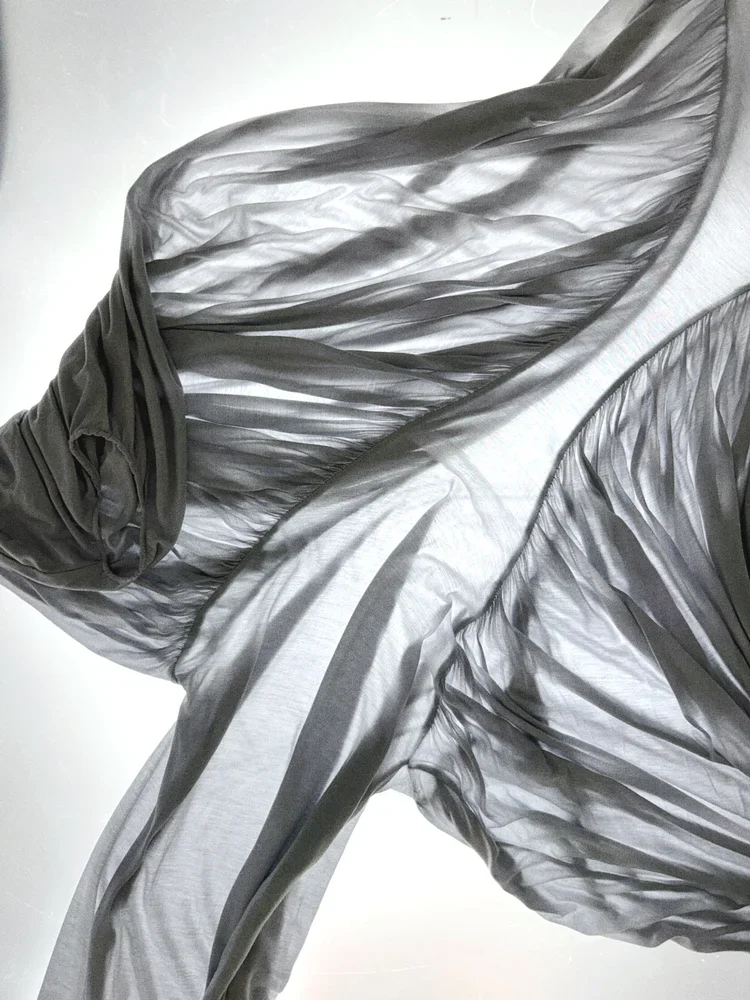 Sheer Grey Jersey Textile Study | 18.01LONDON Fashion Archive
Lightweight sheer grey jersey fabric photographed to highlight transparency, movement and fluid drape.
Transparent jersey textile reference exploring movement, drape and lightweight constr
