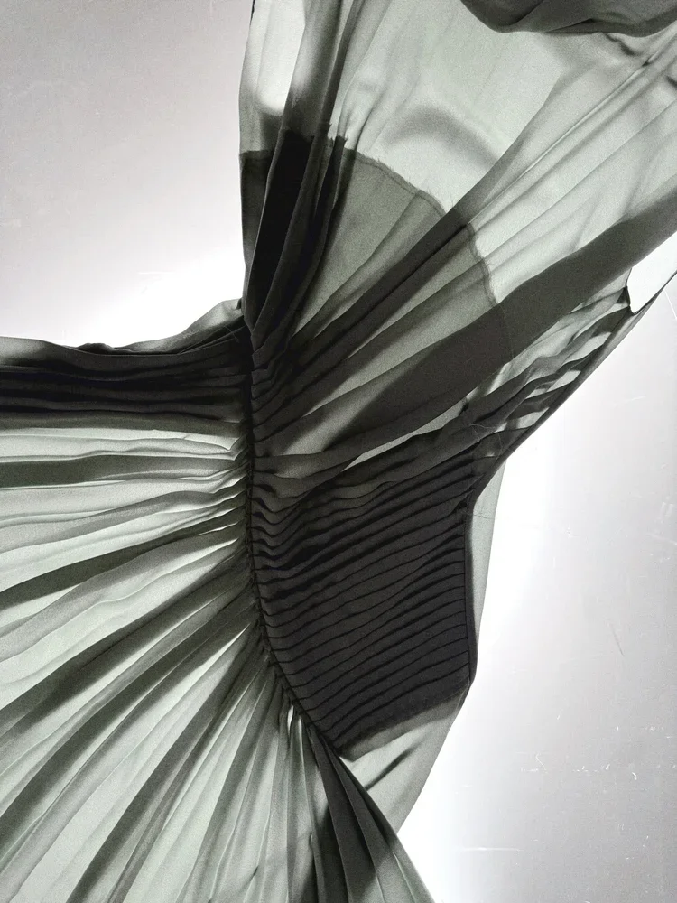
Pleated Twist Dress | 18.01LONDON

Sheer pleated dress with sculptural twist detailing from the 18.01LONDON fashion archive.

Precision pleating creating architectural form.
