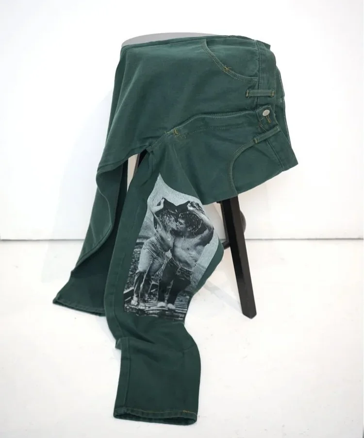 1980s Transfer Print Lovers Jeans
Rare 1980s green transfer print jeans featuring a photographic graphic print, preserved within the 18.01LONDON fashion archive.
Rare vintage denim with graphic transfer print detailing, available for luxury fashion r