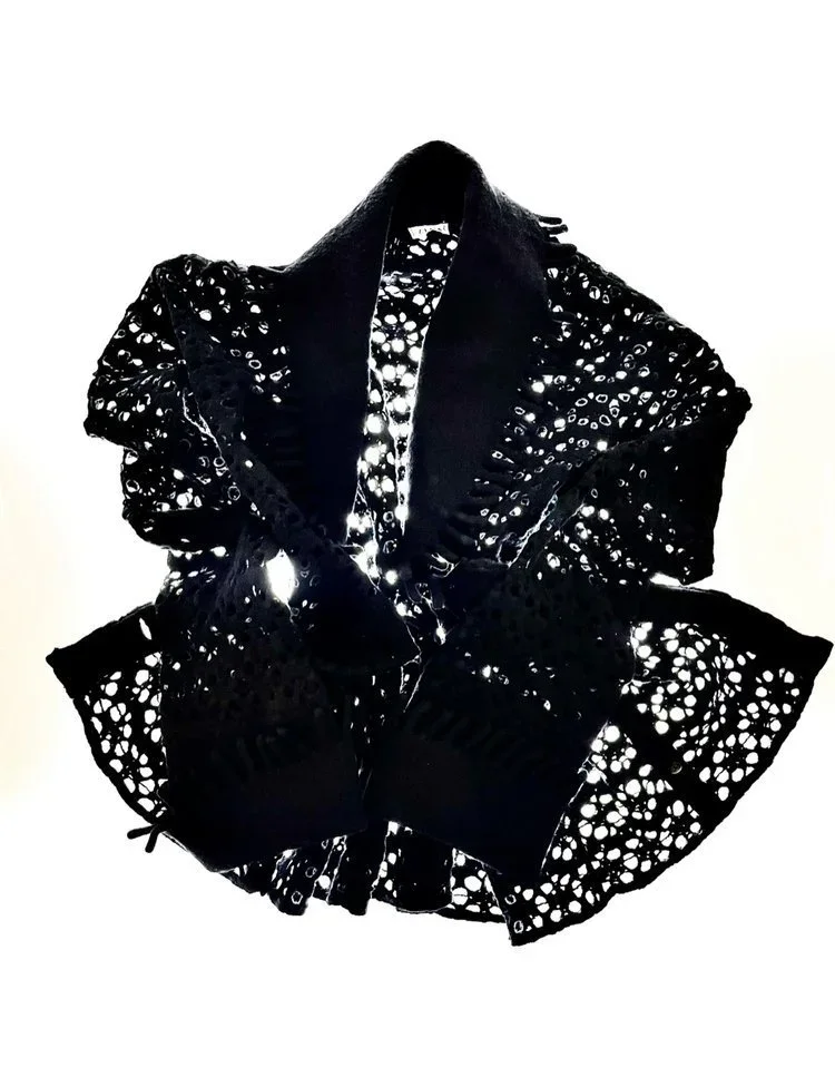 Alaia Knitted jacket with laser-Cut effect Textile Development
Laser-cut black textile exploring engineered perforation, geometric patterning and the interaction between negative space and garment structure.
Removing material becomes a construction t