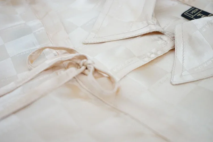 Vintage Ferragamo Silk Pyjama Set | 18.01LONDON Fashion Archive

Detail of a Ferragamo silk pyjama shirt featuring tonal jacquard fabric and delicate tie fastening.

Luxury Ferragamo silk loungewear exploring tonal jacquard weaving, soft tailoring an
