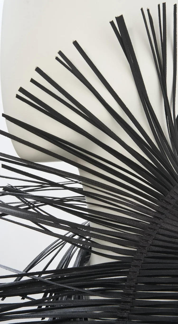 Pleated Laser Cut Textile Detail | Fashion Research Archive London
Architectural pleated textile with precision laser-cut strips creating sculptural movement and volume.
A close study of precision-cut textile engineering, combining pleated constructi