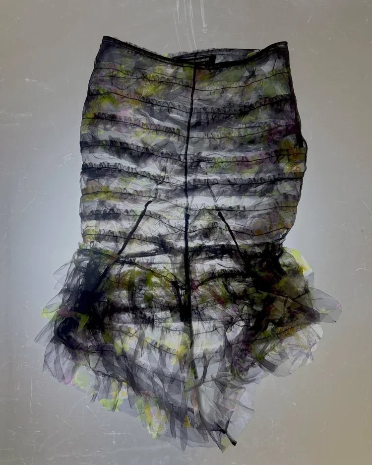 Comme des Garçons Printed Floral Tulle Skirt | Fashion Research Archive London
Printed floral tulle skirt with layered ruching, sheer construction and ruffled hem by Comme des Garçons.
A Comme des Garçons skirt exploring layered transparency through 