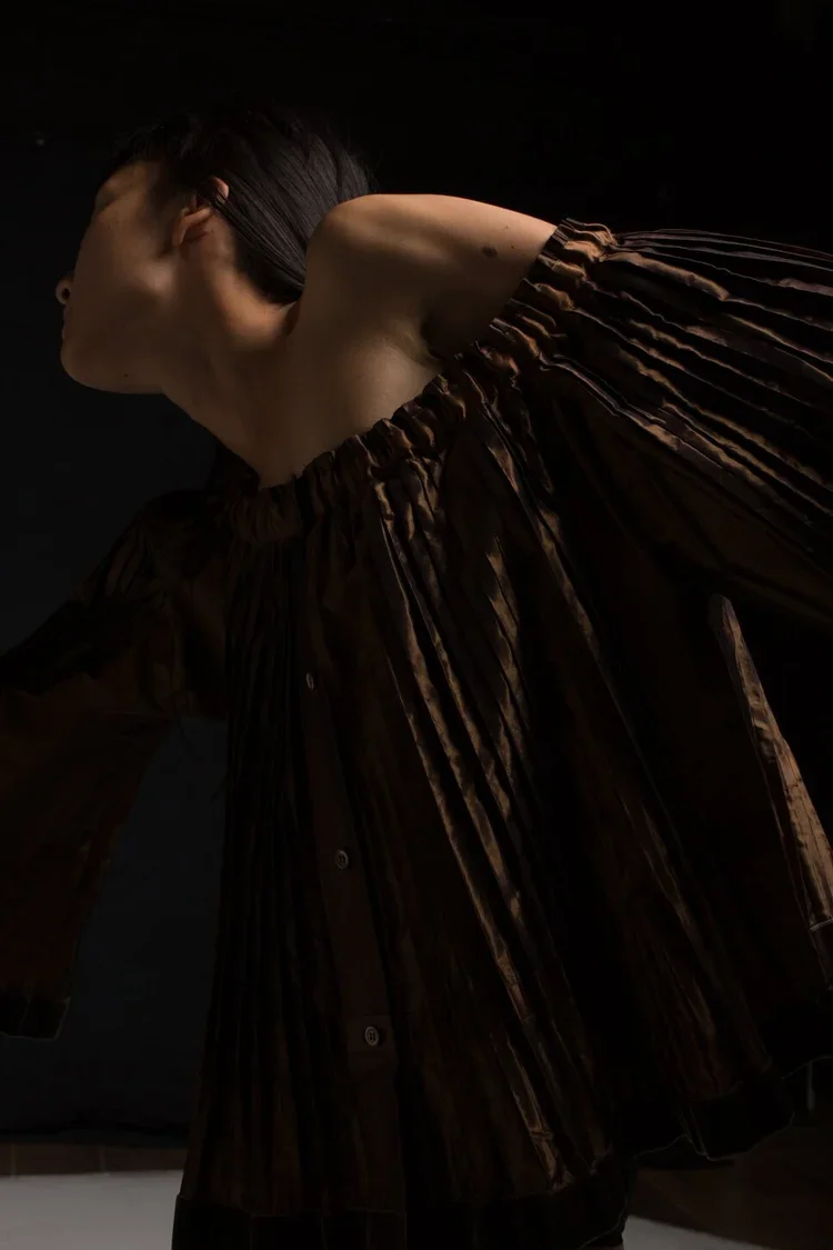 Vintage Kenzo off shoulder taffeta pleat top, with velvet trim, Pleated Volume & Movement
Finely pleated garment emphasising directional movement, soft volume and fluid construction through repeated folds.
The garment expands and contracts with the b