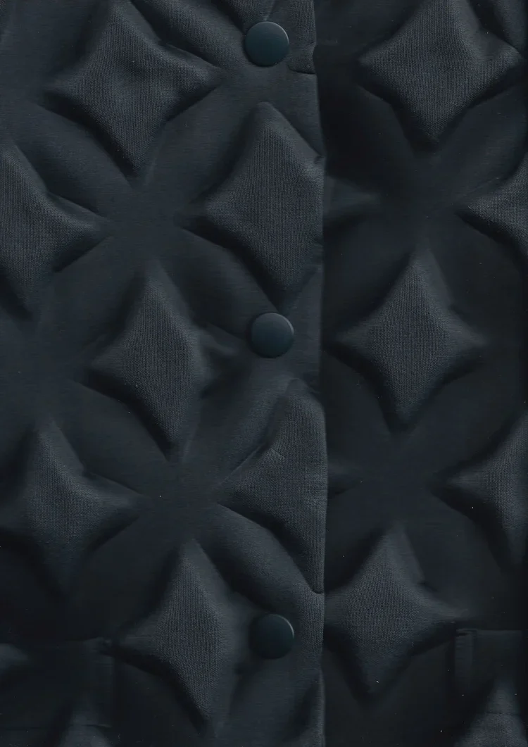 Issey Miyake Eggbox Neoprene Jacket | Fashion Research Archive London
Close-up of Issey Miyake neoprene jacket featuring raised geometric padded 'eggbox' surface construction.
A close study of Issey Miyake's innovative padded neoprene construction, c