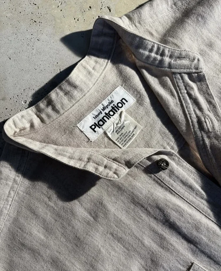 Issey Miyake Plantation Linen Shirt | 18.01LONDON Fashion Archive
Close-up of a rare Issey Miyake Plantation linen shirt highlighting its natural texture, minimalist collar and original woven label.

Rare Issey Miyake Plantation linen shirt exploring