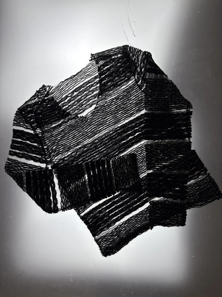 Japanese Mesh Knit Textile Study | 18.01LONDON Fashion Archive

Black Japanese mesh knit garment featuring alternating openwork and textured woven bands.

Experimental Japanese knitwear exploring transparency, engineered textiles and innovative surfa