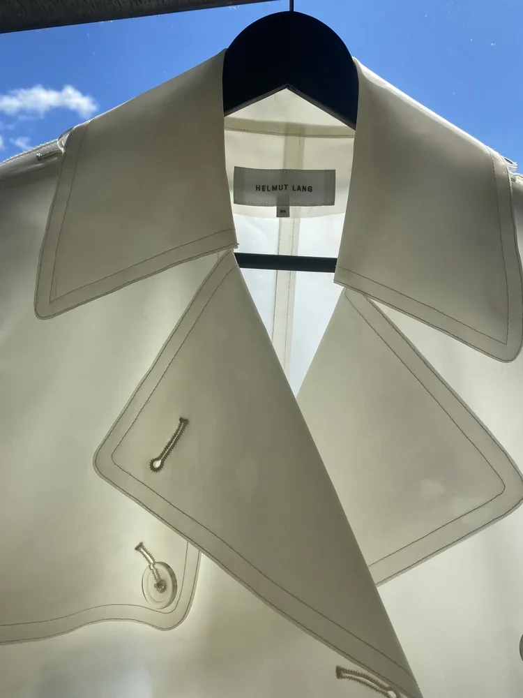 Helmut Lang White Rubber Trench Coat | 18.01LONDON Archive

Vintage Helmut Lang white rubber trench coat photographed against natural light highlighting translucent construction.

Rare Helmut Lang rubber trench coat exploring minimalist construction,