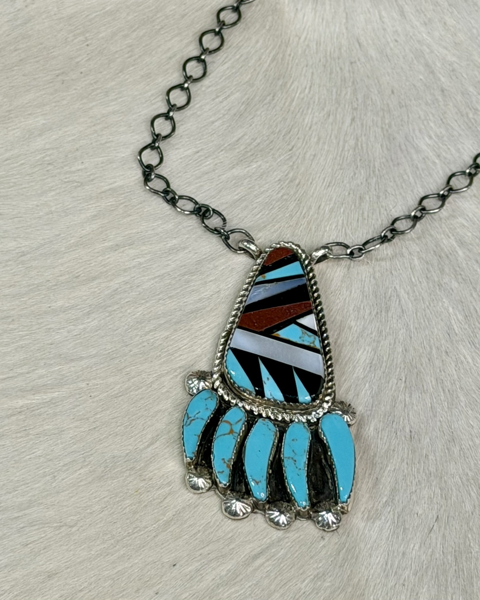 turquoise coral jet mother of pearl inlay Navajo pendant close up