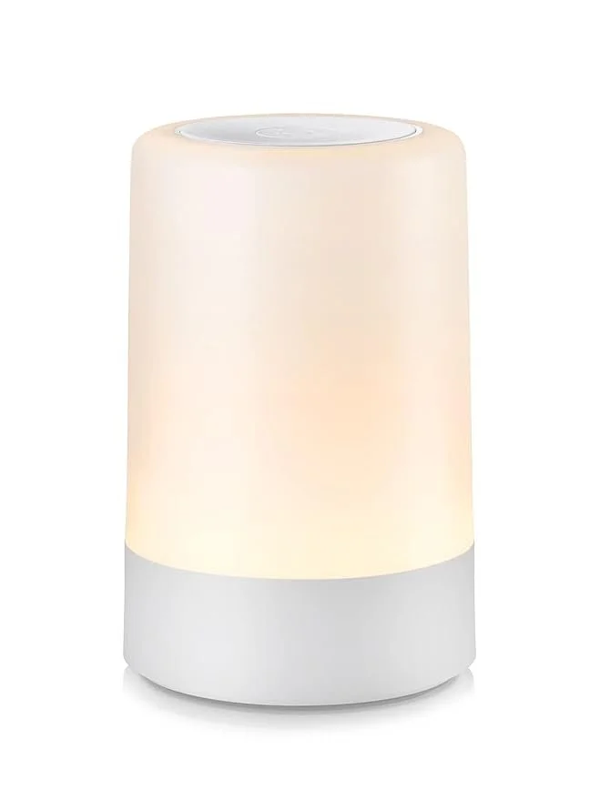 A modern white LED night light with a soft glow and sleek cylindrical design.