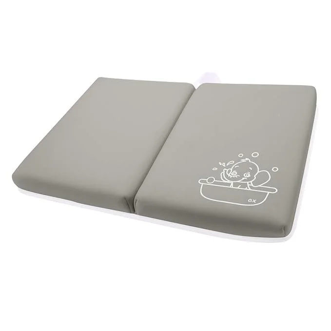Gray changing pad with a cartoon baby illustration on it.