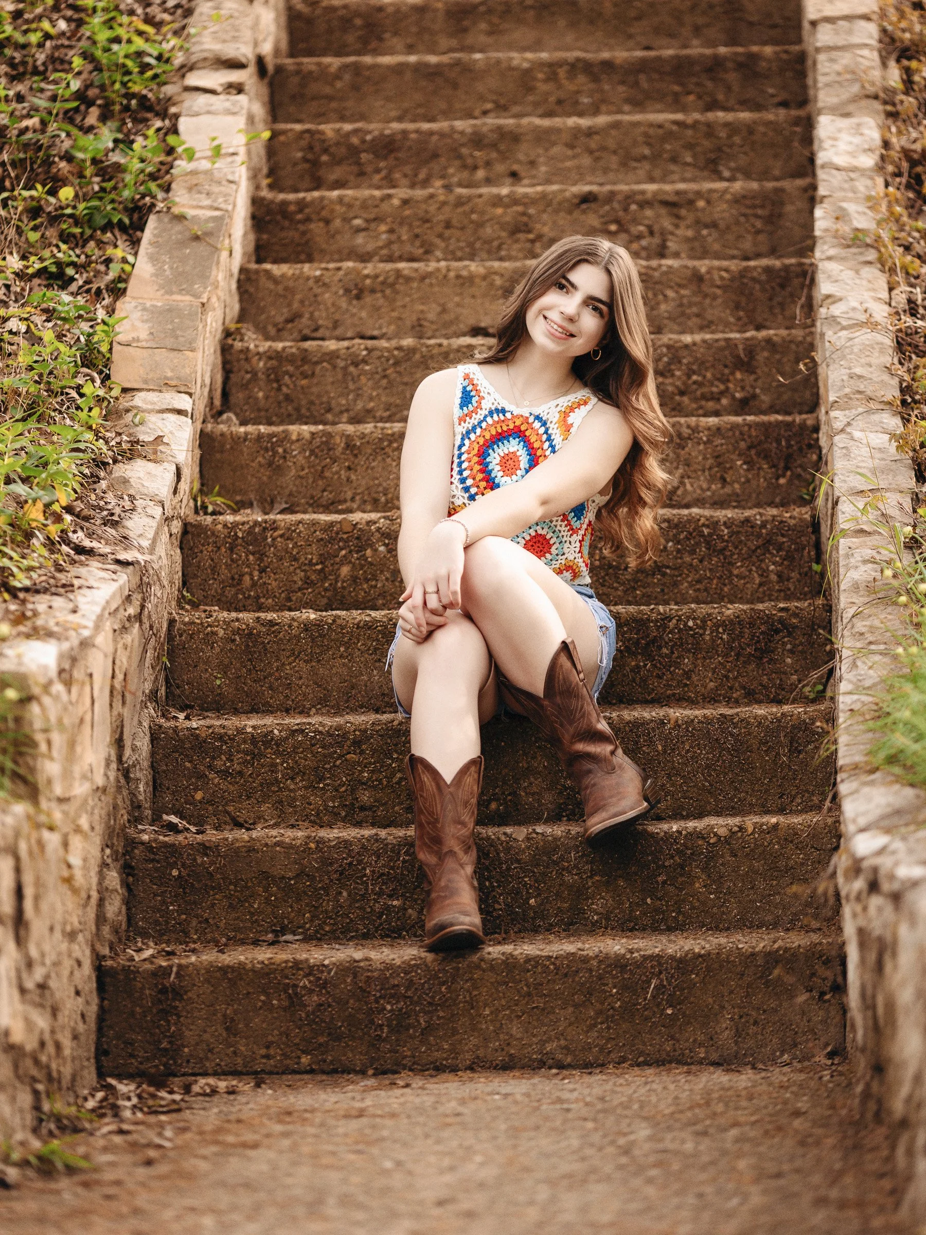 Texas-inspired senior portrait with boots and fall tones.