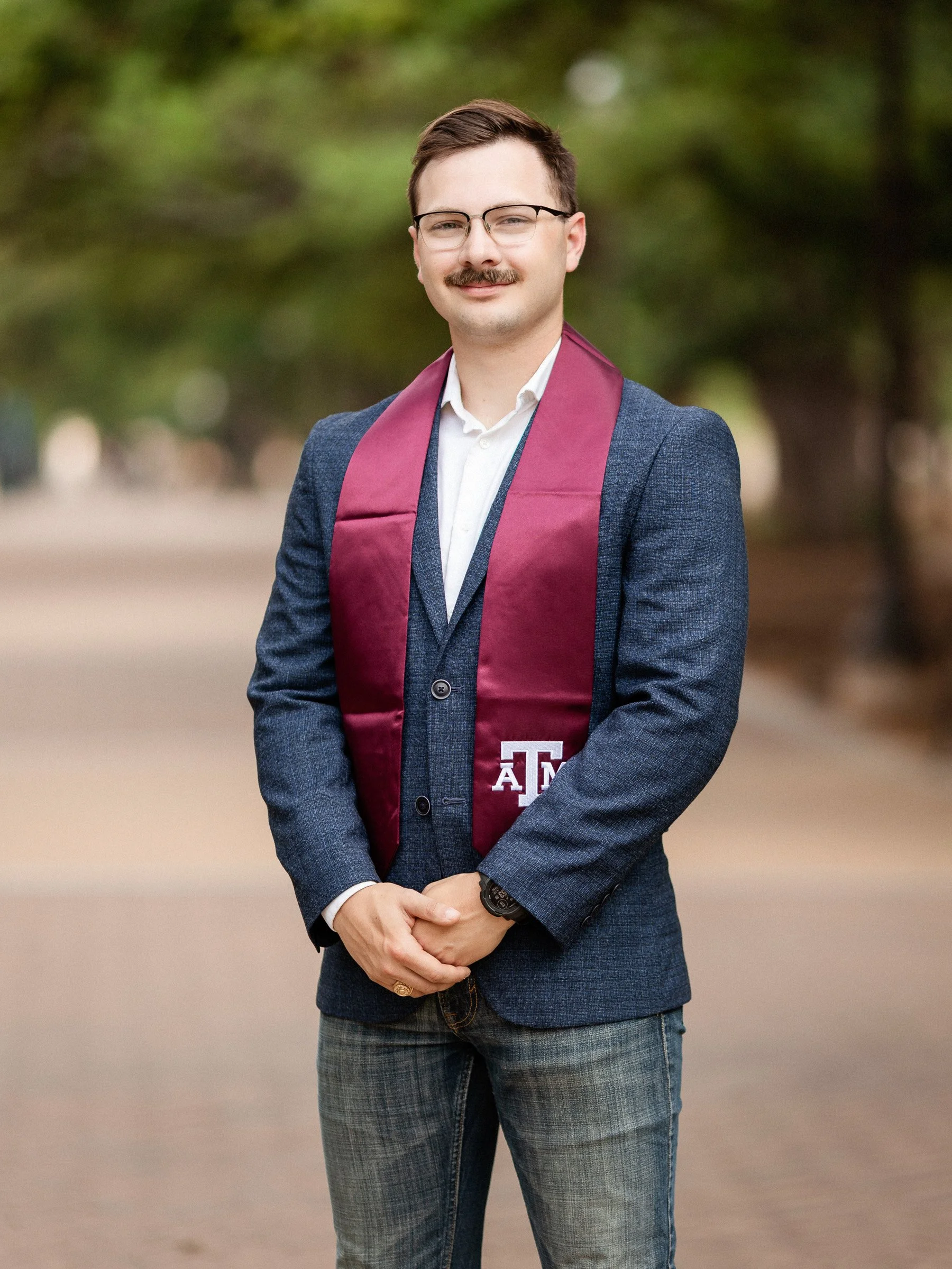 Close-up senior portrait emphasizing confidence and warmth.