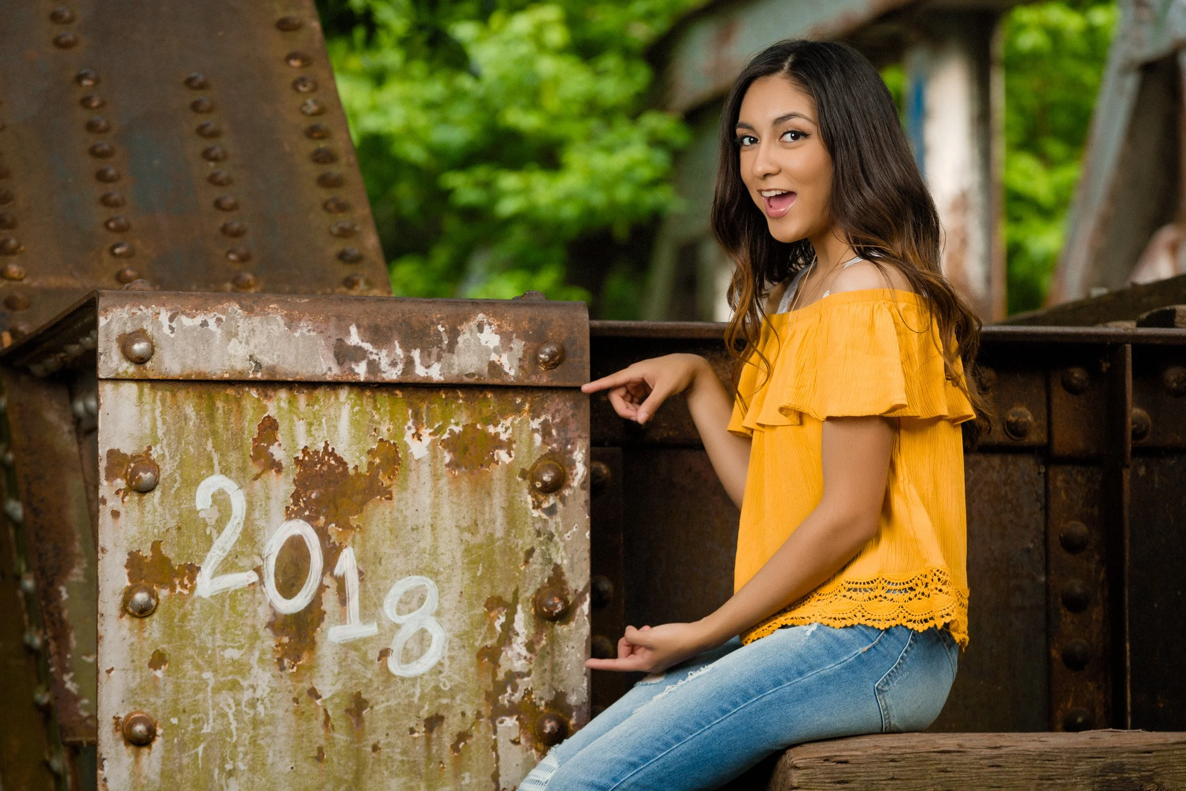 Classic cap and gown senior portrait with modern composition.