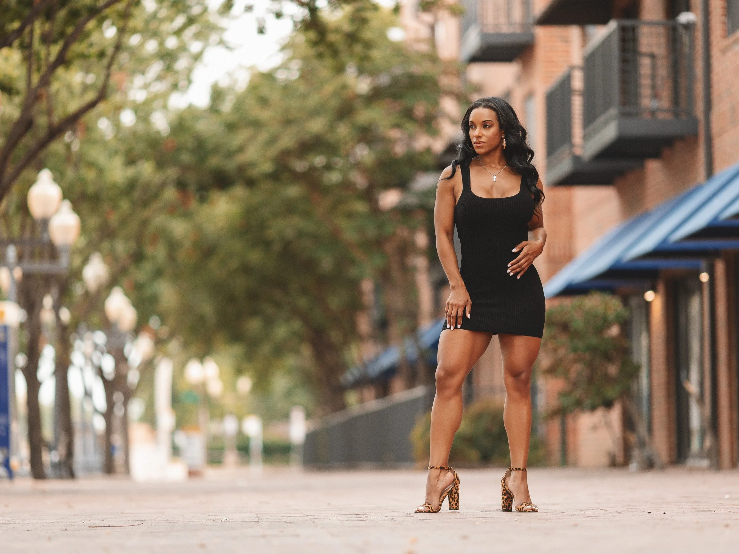 Urban lifestyle portrait of woman in black mini dress on downtown Dallas street | Photo by rgmphotography