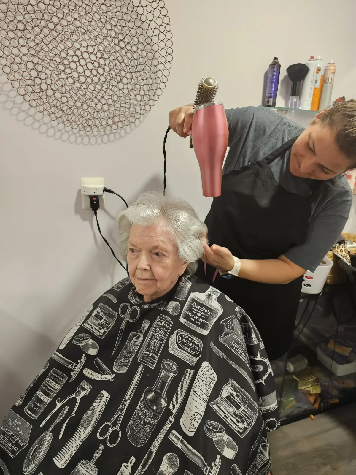Resident getting a haircut and a style by Broad Creek Manor's in house hairdresser.