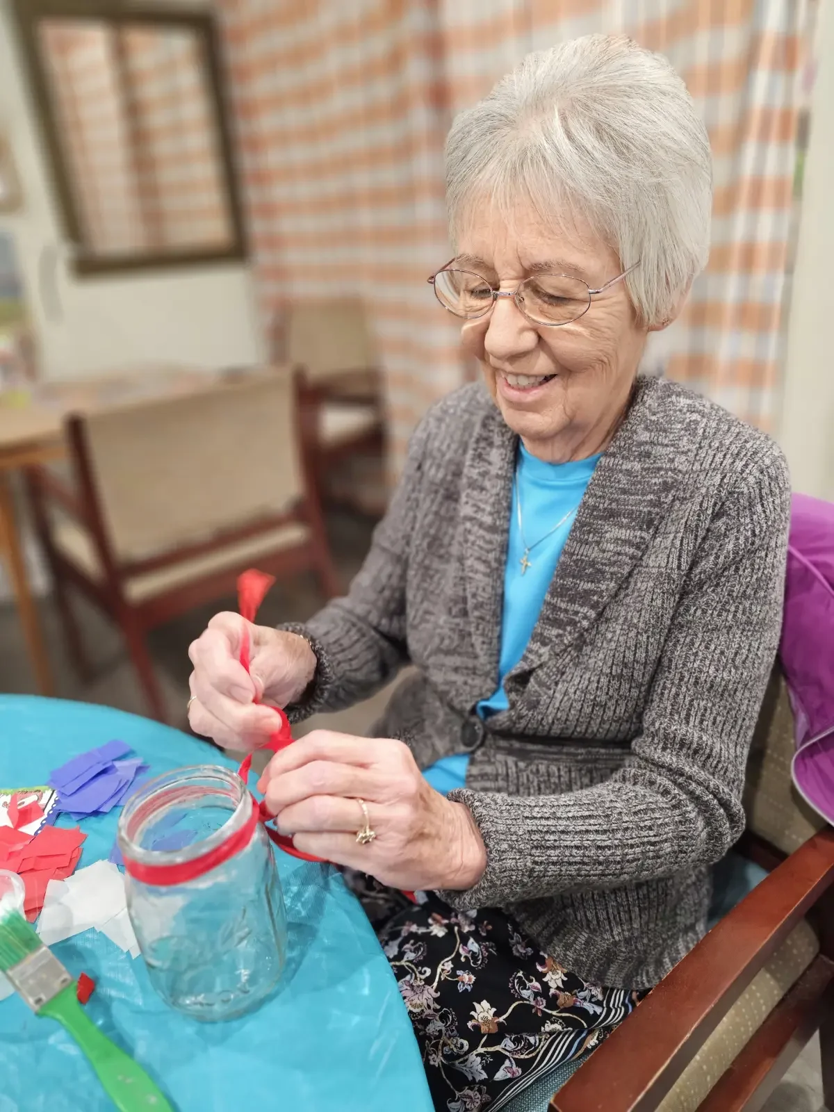 Resident enjoying a craft activity in the activity room.
