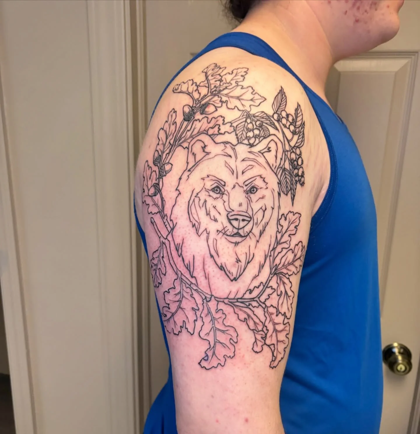 Work in progress bear+service berry shoulder piece by @goatwitchtattoo