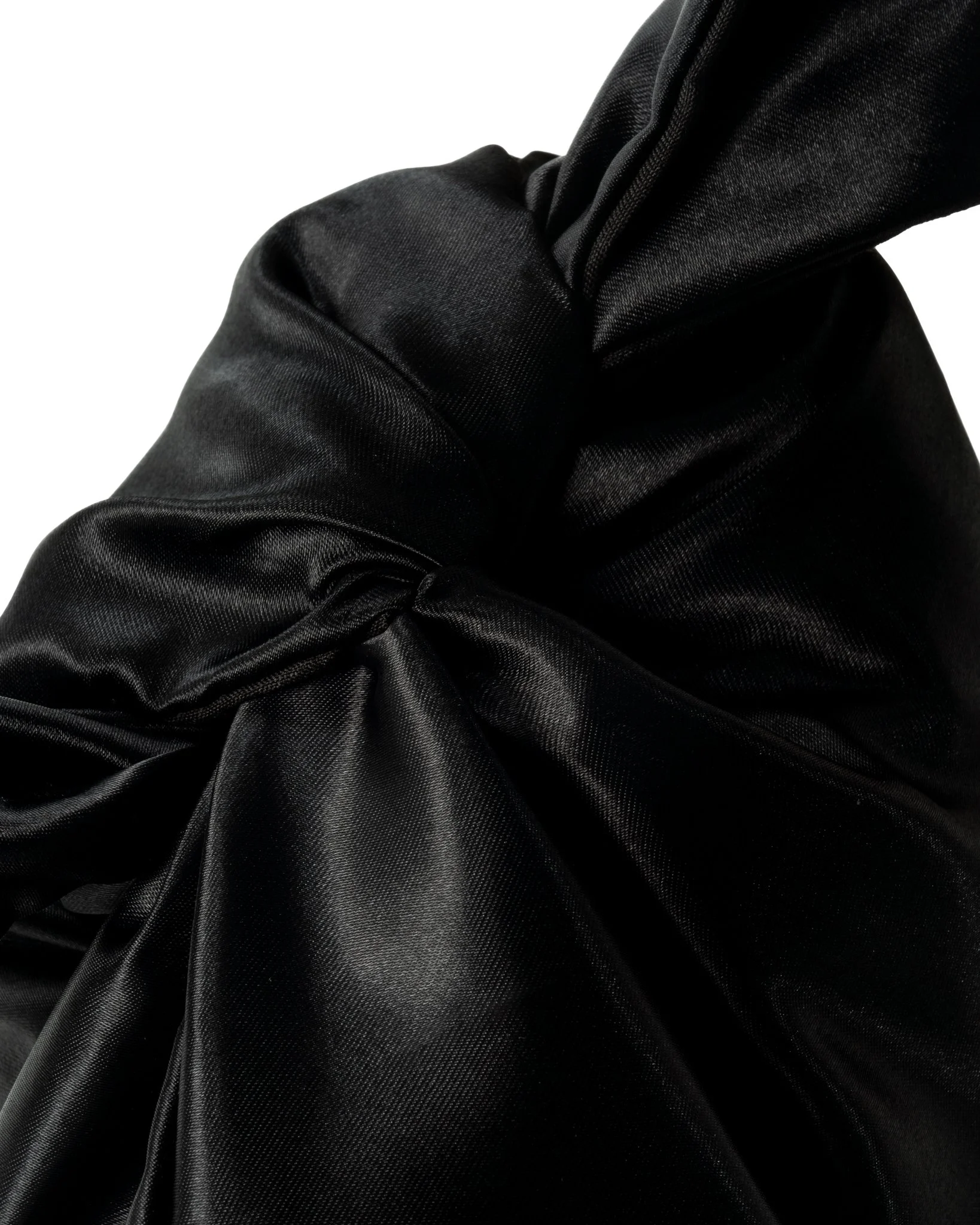 Close-up of black satin fabric with folds and sheen.