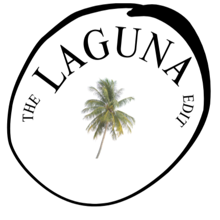 A small tropical island with a single palm tree and sandy beach.