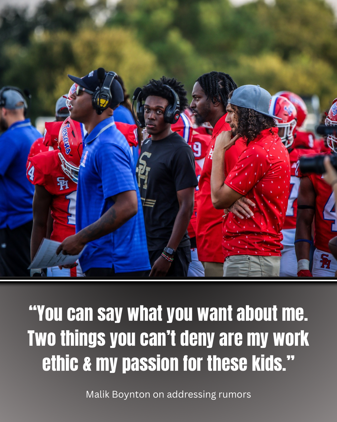 A group of African American football players and coaches standing on the sideline during a game, wearing red, blue, and black team uniforms and headsets. The background shows trees and a clear sky.