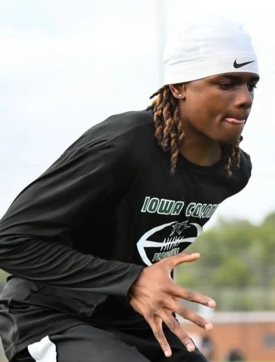 Athlete in black athletic wear with a white Nike headband.