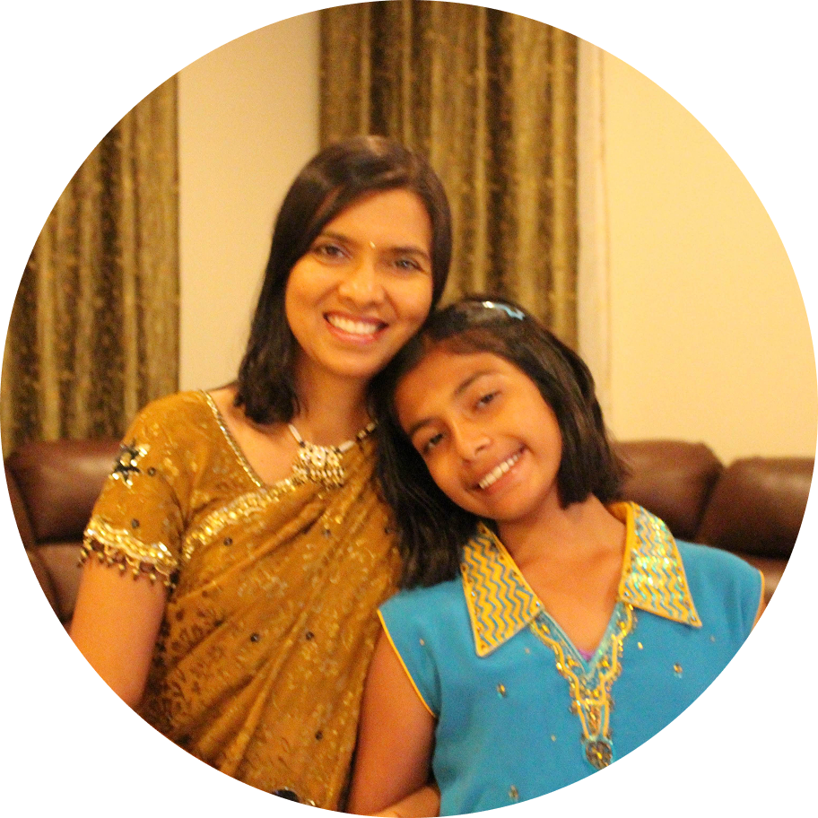A portrait of a young woman with long dark hair tied in a ponytail, wearing a strapless white dress and a necklace, looking to her left against a plain white background.