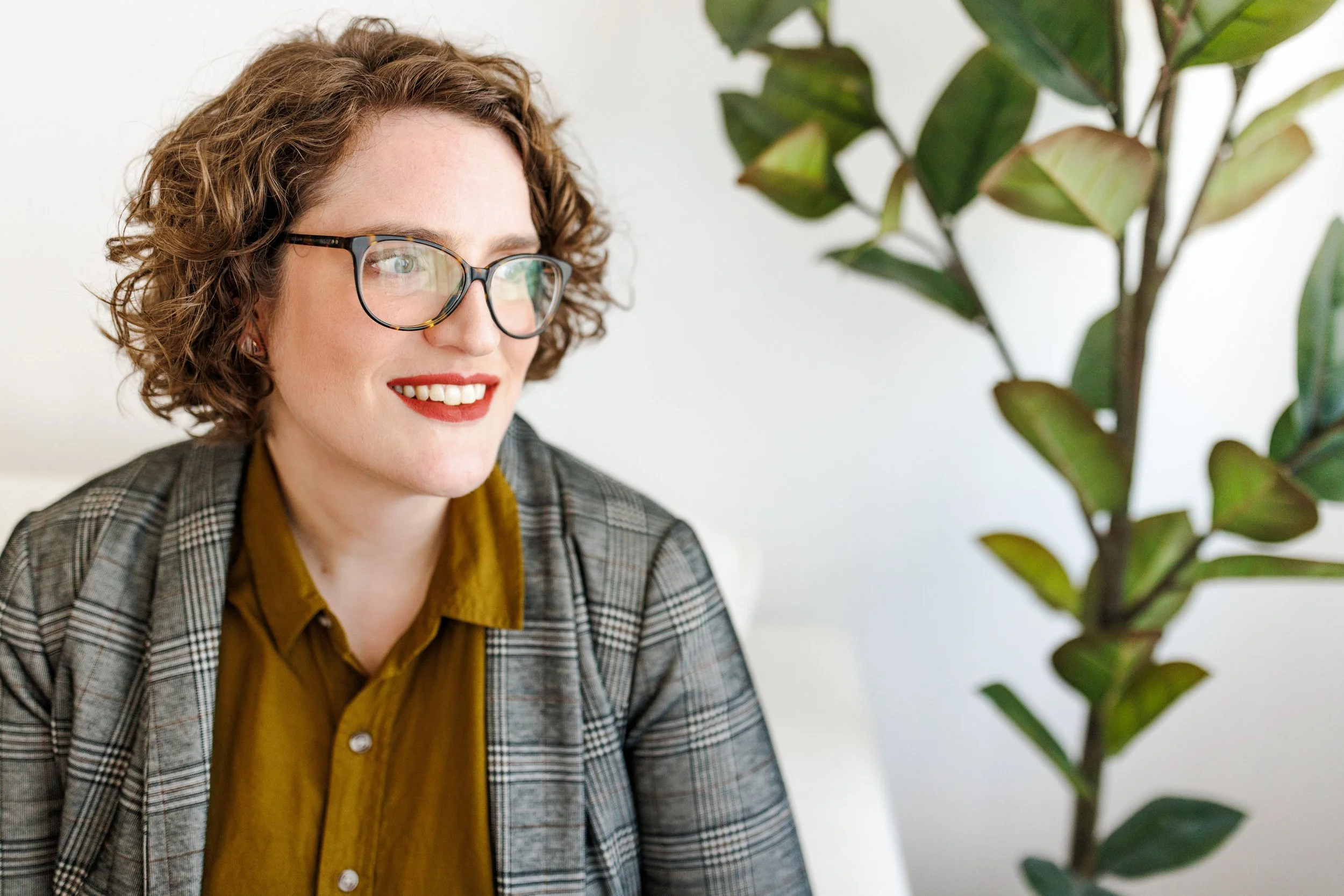 white person, brown hair, with glasses, looking to the right.
