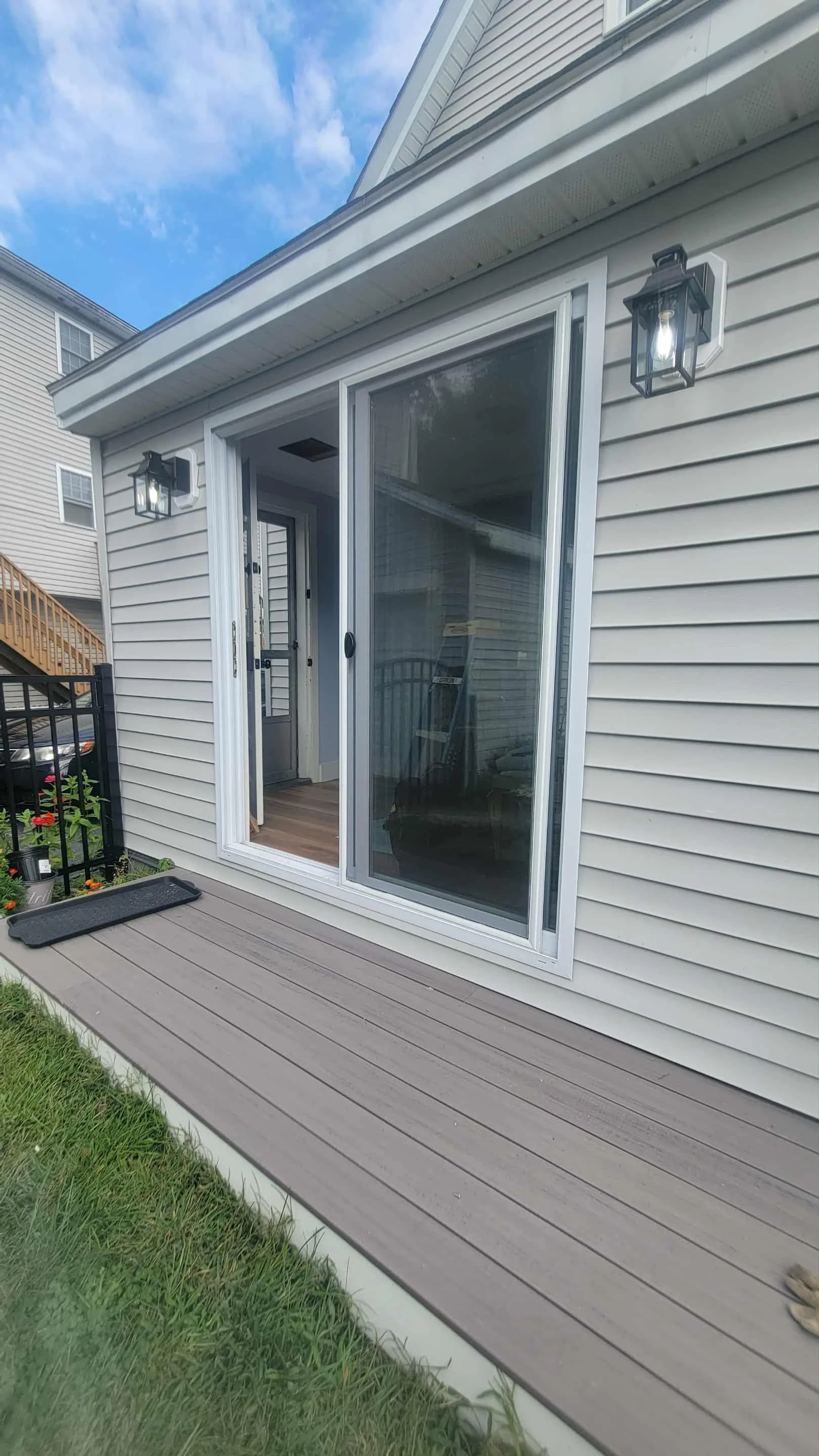 outdoor lights installed on vinyl siding in lowell ma both sconces have daylight sensors and on a switch