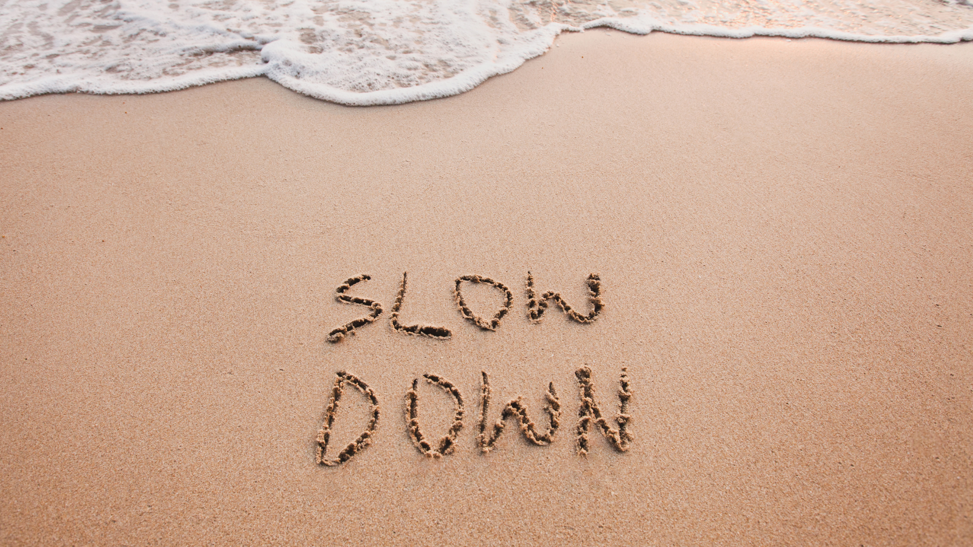 Beach with water, words: slow down. Nervous system regulation. Breathwork. Meditation
