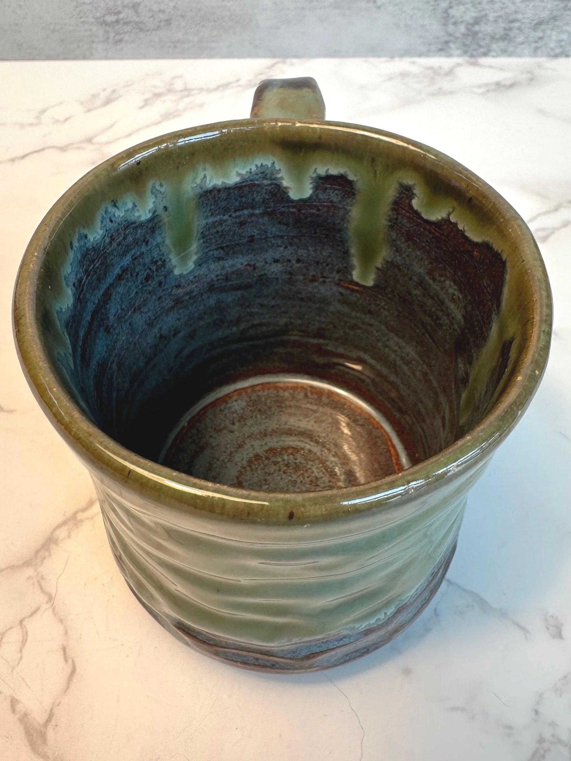 Top view Handmade ceramic mug in rustic green glaze, 11 ounce stoneware mug