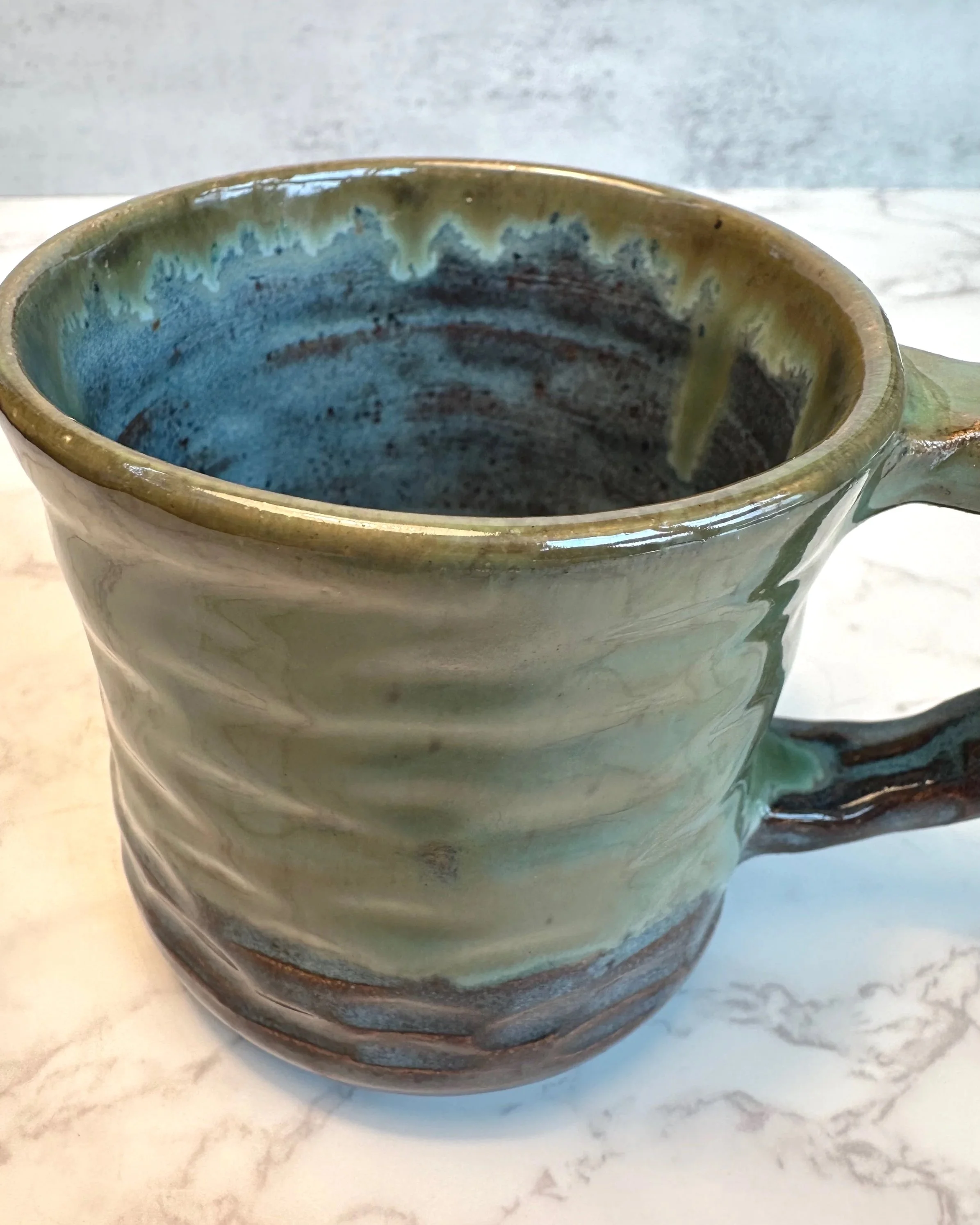 Rim of Handmade ceramic mug in rustic green glaze, 11 ounce stoneware mug