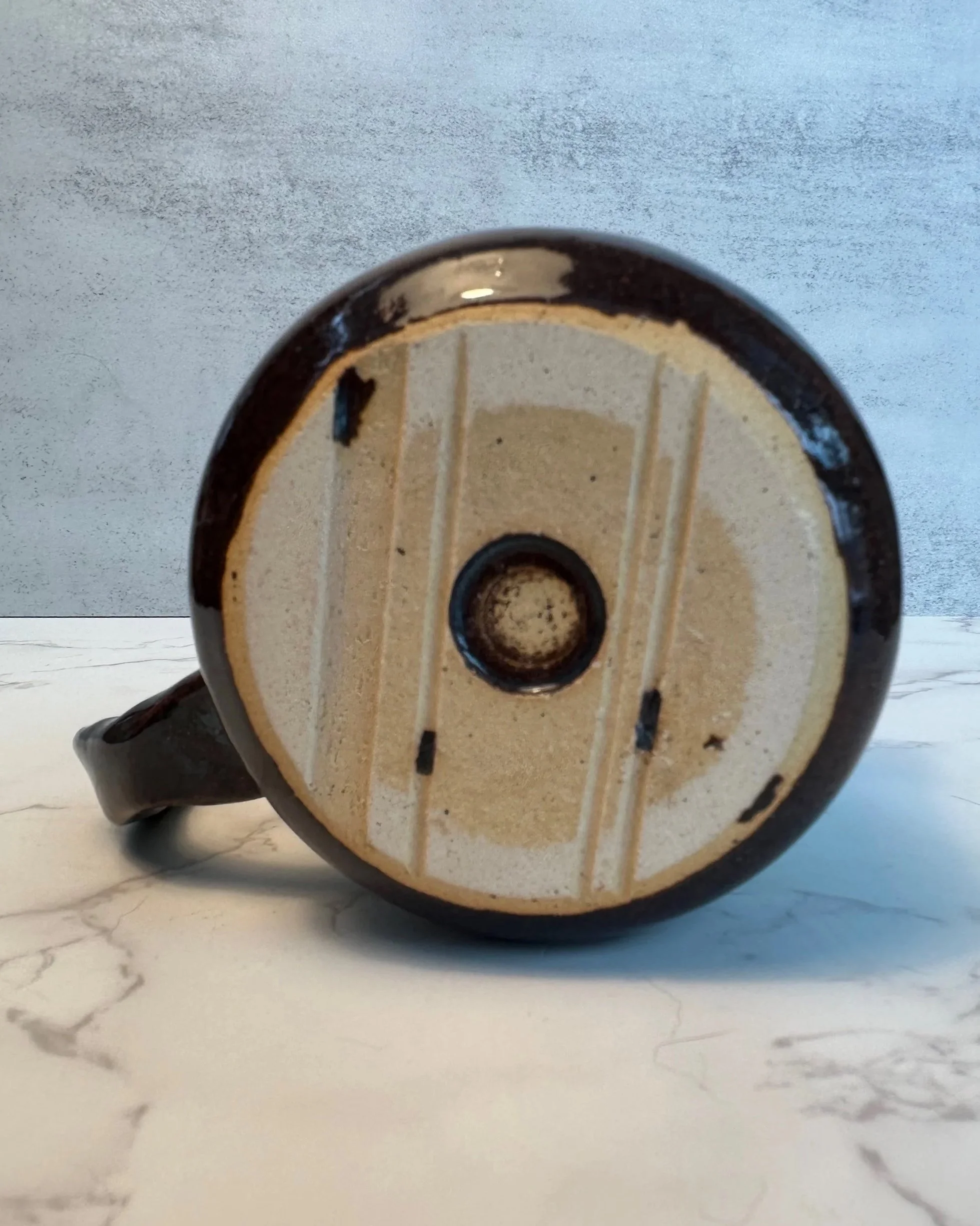 Bottom foot of Handmade ceramic mug in rustic green glaze, 11 ounce stoneware mug