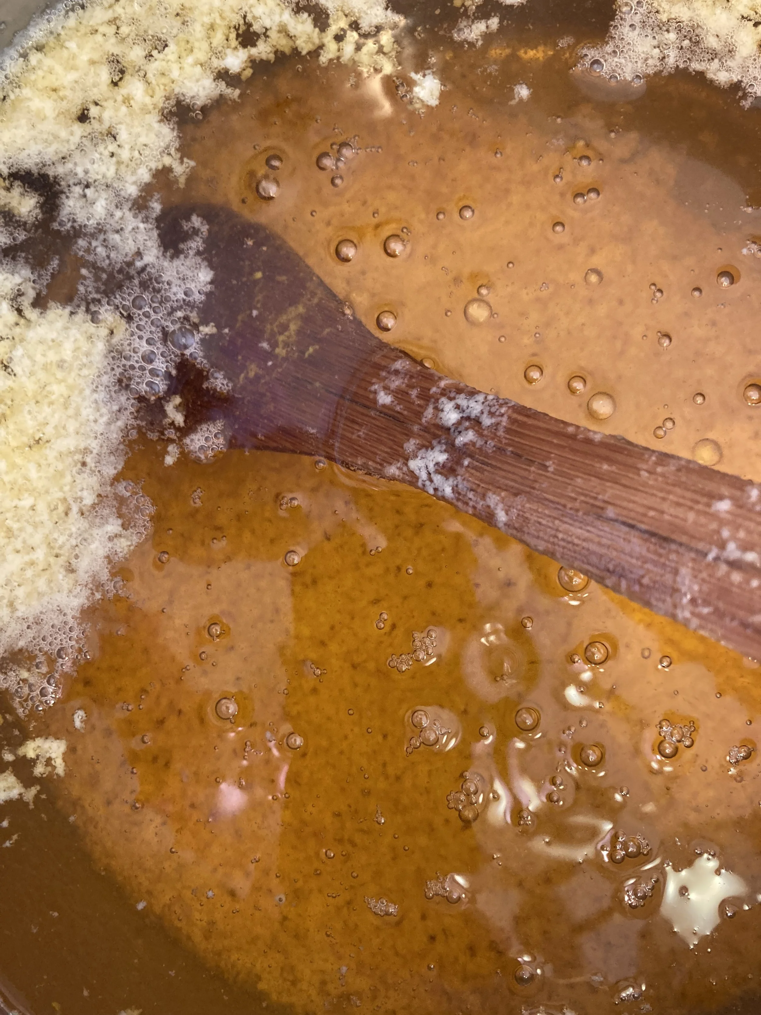 golden ghee with solids at the bottom of the pot
