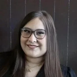 Young Hispanic woman with glasses smiling