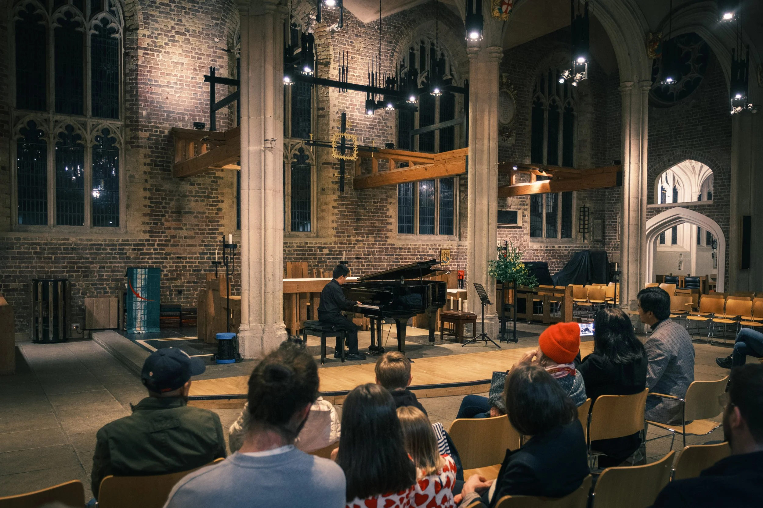 A London music venue prepared for an Inchwise community concert, with a piano, audience seating and a young musician’s performance space.