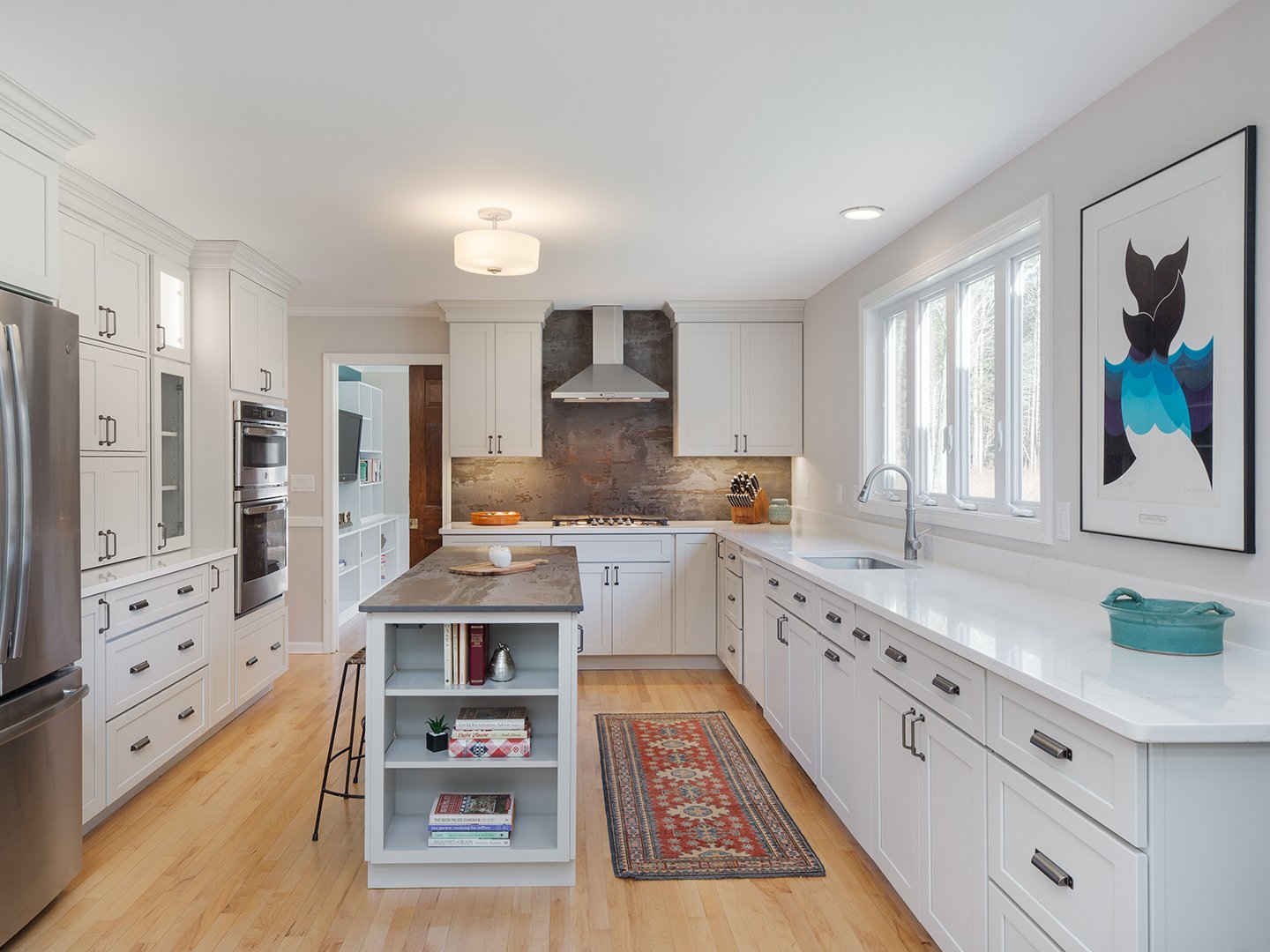 Bright white kitchen cabinets with gray island Southwest Colorado project