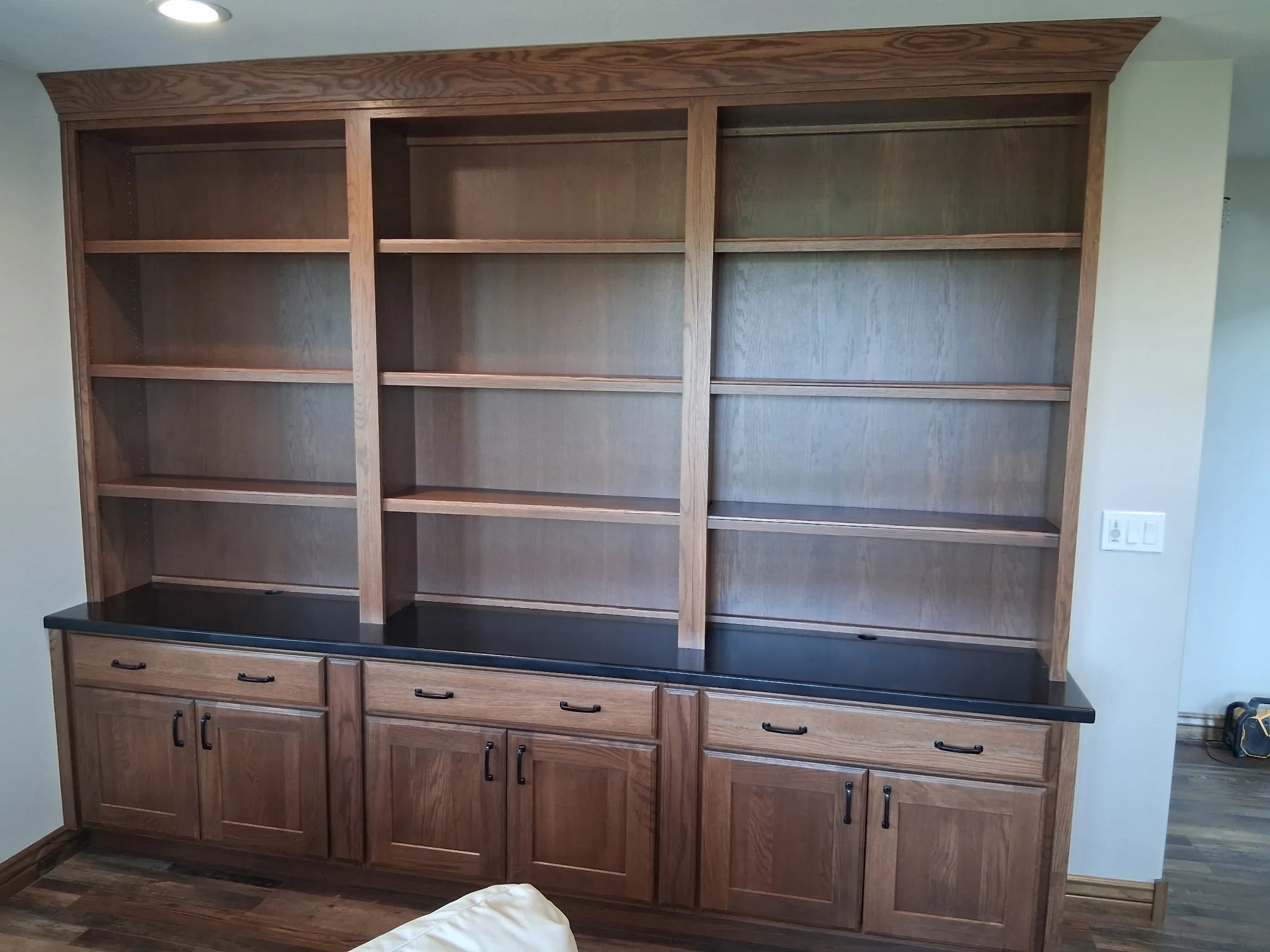 Semi-Custom Library Wall. Bookcase with lower storage and solid surface countertop.