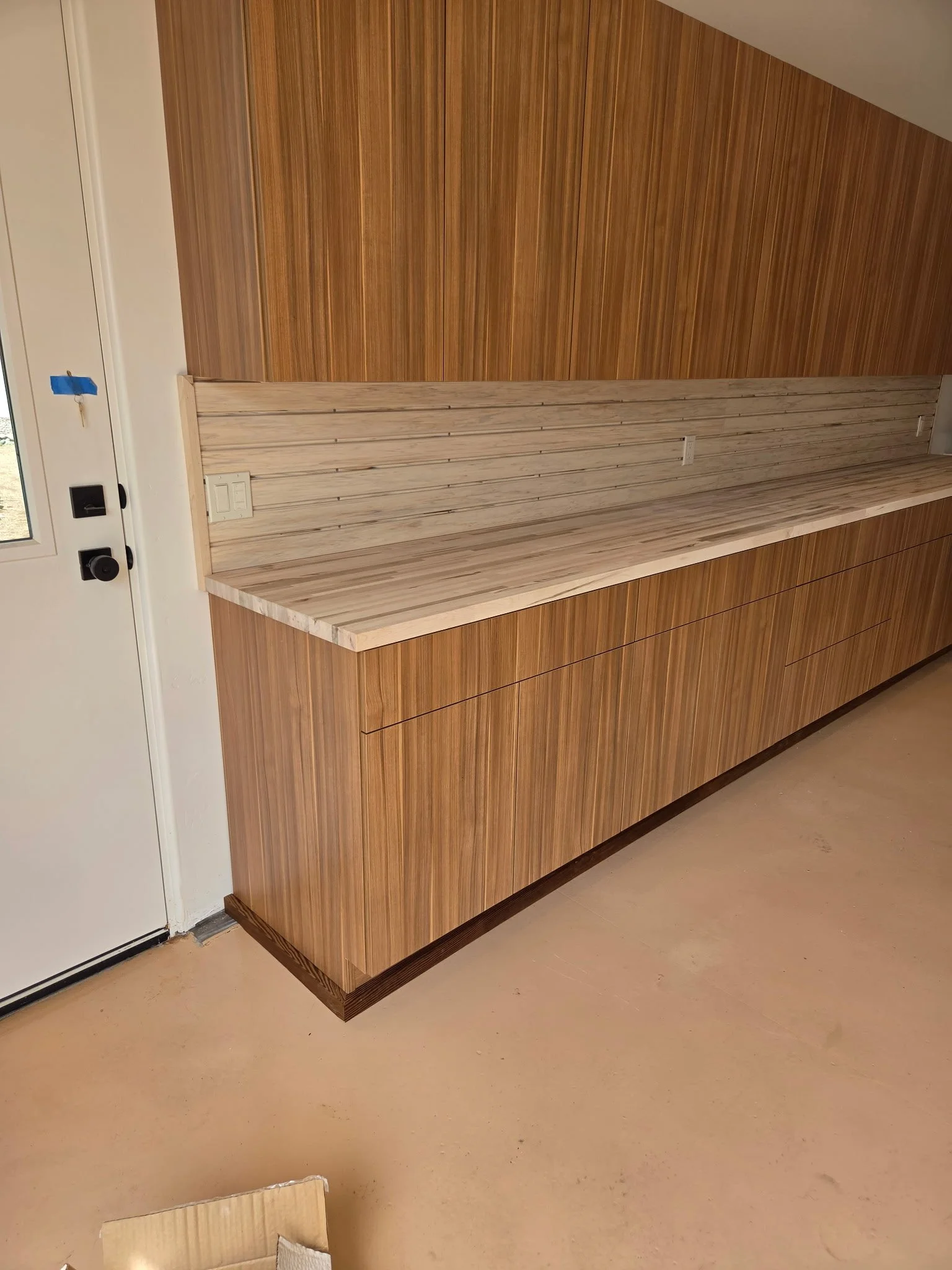 Garage cabinets with butcher block counters and slat wall for tool organization. Collaborative project between Animas Kitchen & Bath and Animas Craft Woodworks.