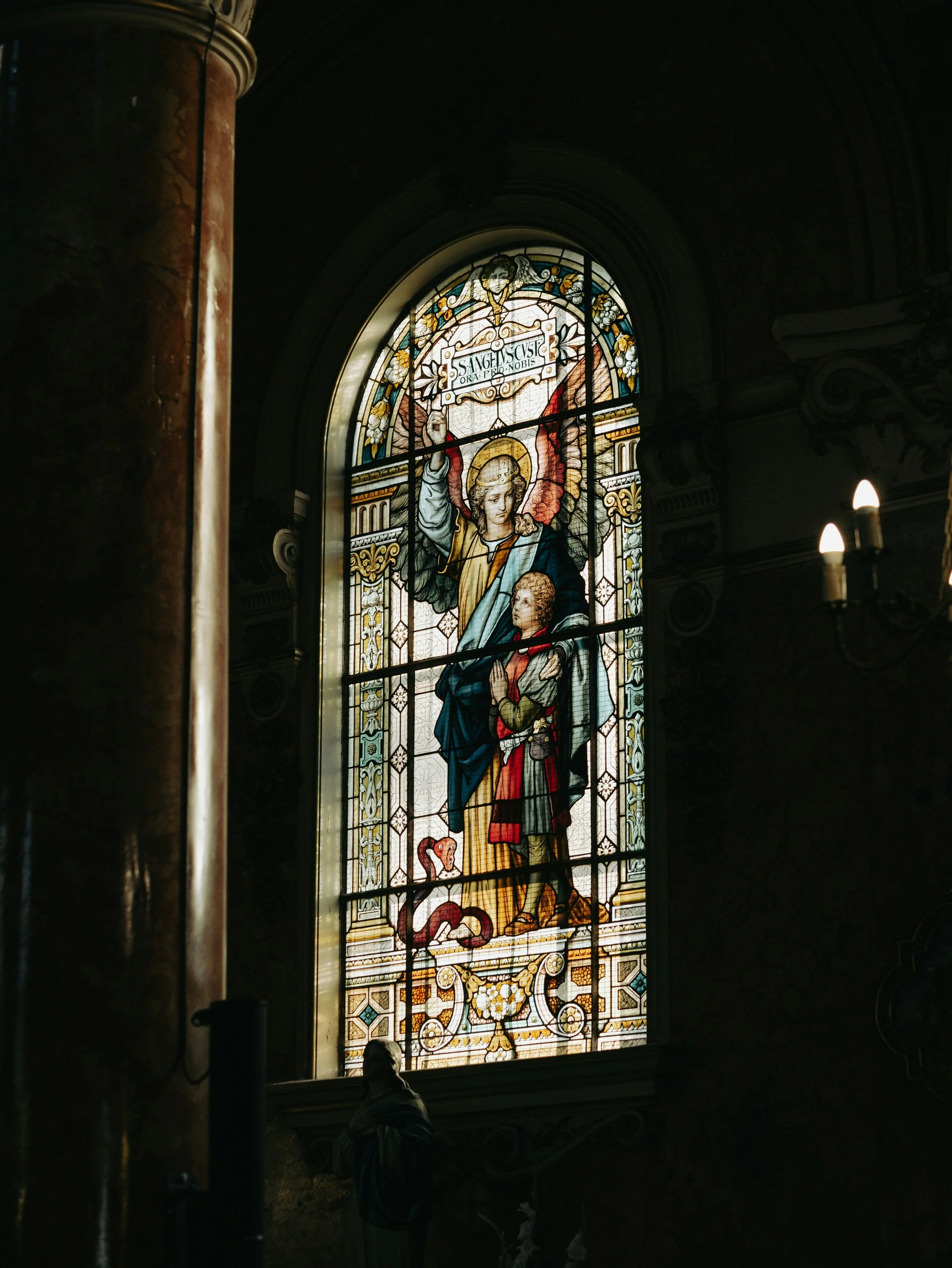 Stained Glass Window with angel and Saint portrayed