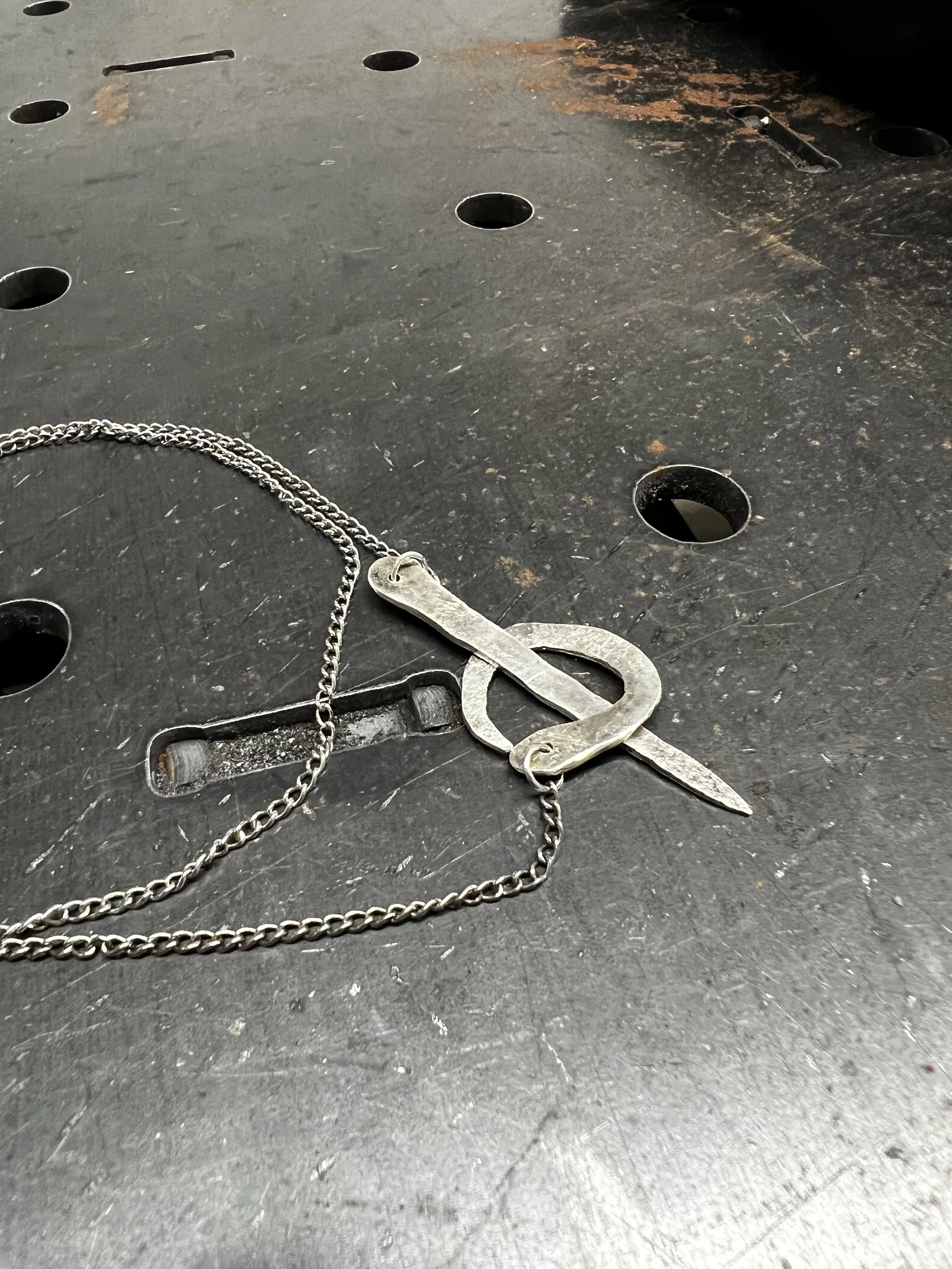 Custom silver sword-shaped necklace by Leif Armstrong