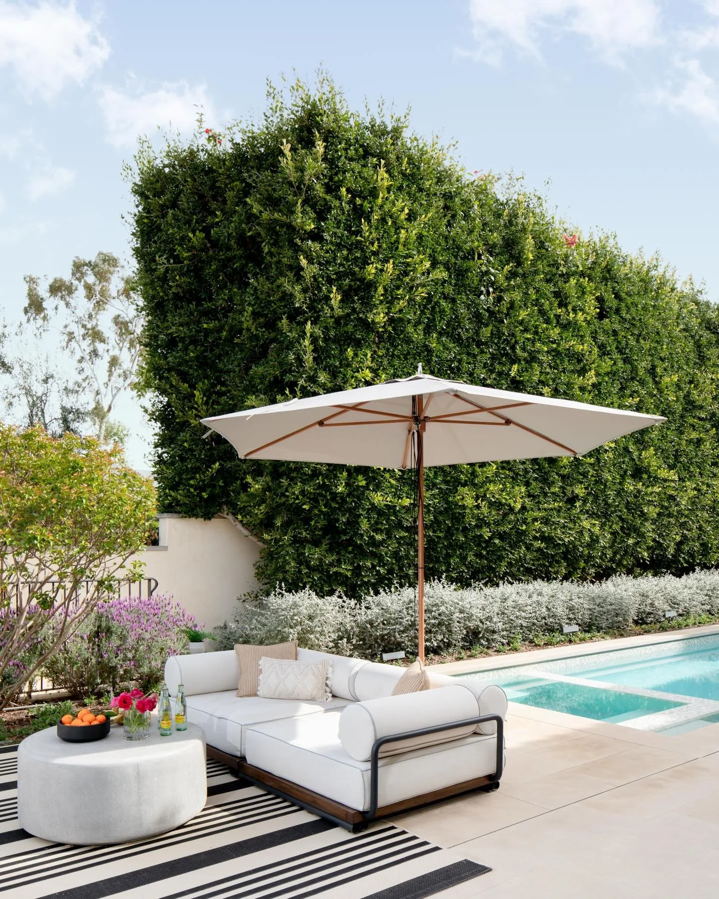 For this grand Mediterranean estate, every exterior decision really mattered, so material selection was front and center. We chose natural limestone in a mix of textures for the hardscape, pool coping, fire pit, and water feature to keep everything l