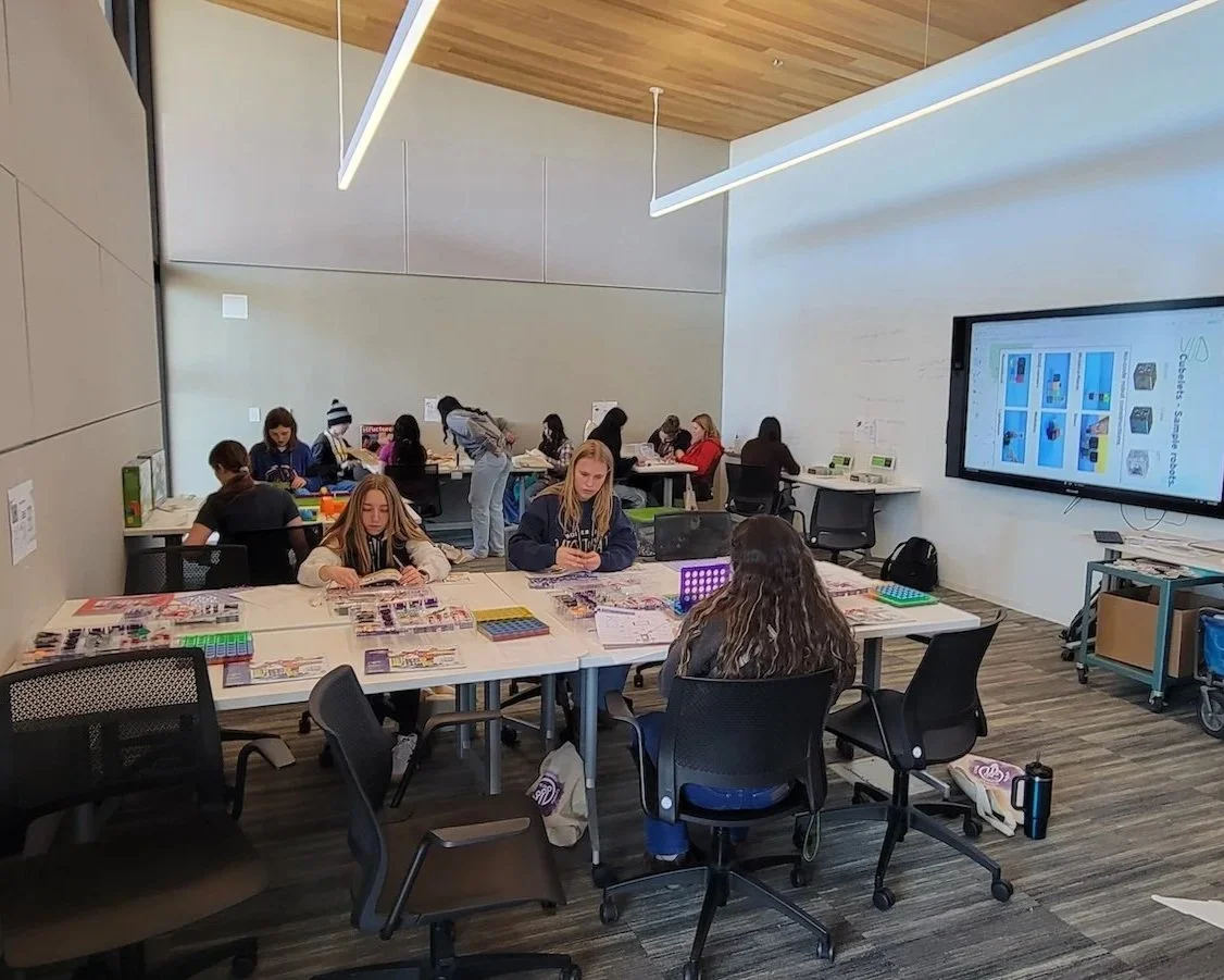 Classroom of students working on craft projects.
