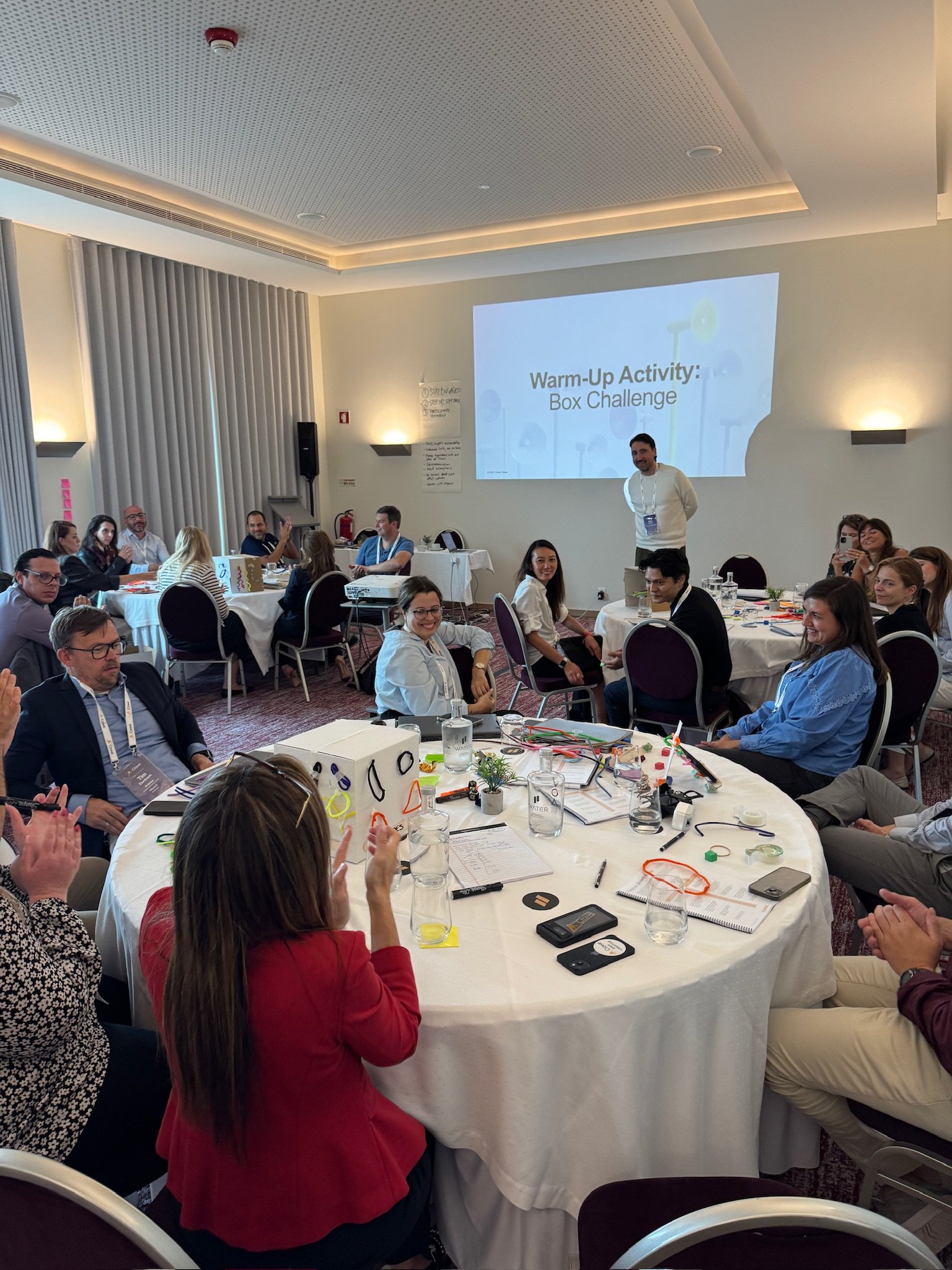 18 Coffees facilitator speaking in front of audience.