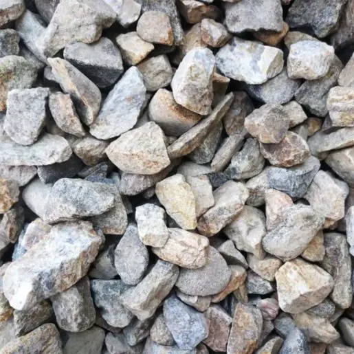 Pile of small, irregularly shaped gray and beige rocks.
