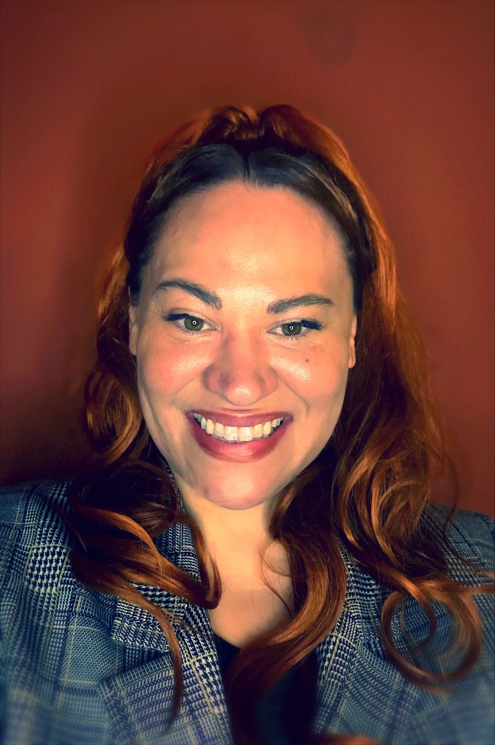 Headshot of Cassondra Axen, PhD, Lead Scientific Consultant at Streamline BioOps, smiling in a checkered blazer and black top against a brown background.